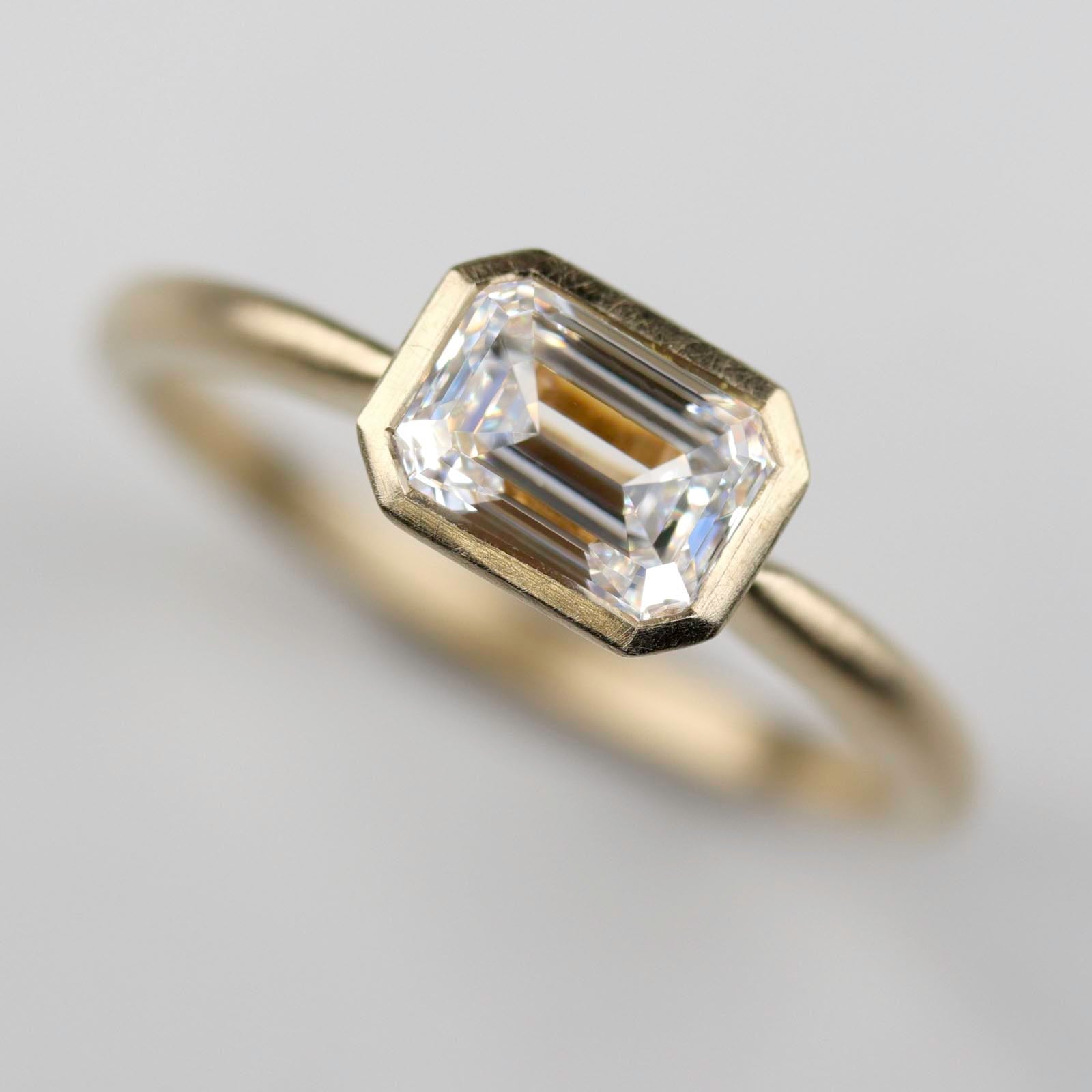 East-West Emerald-cut Bezel Solitaire Engagement Ring